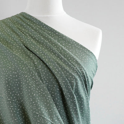 Arizona - Pistachio Green Ticker Tape, Single Jersey Cotton Elastane Print Fabric Mannequin Close Up Image from Patternsandplains.com