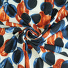 Portia - Blue and Orange Grapes Stretch Jersey Fabric from John Kaldor Detail Swirl Image from Patternsandplains.com