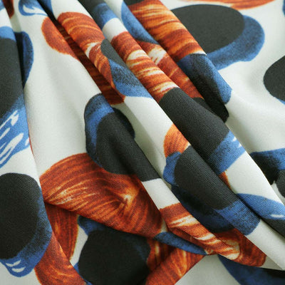 Portia - Blue and Orange Grapes Stretch Jersey Fabric from John Kaldor Feature Image from Patternsandplains.com
