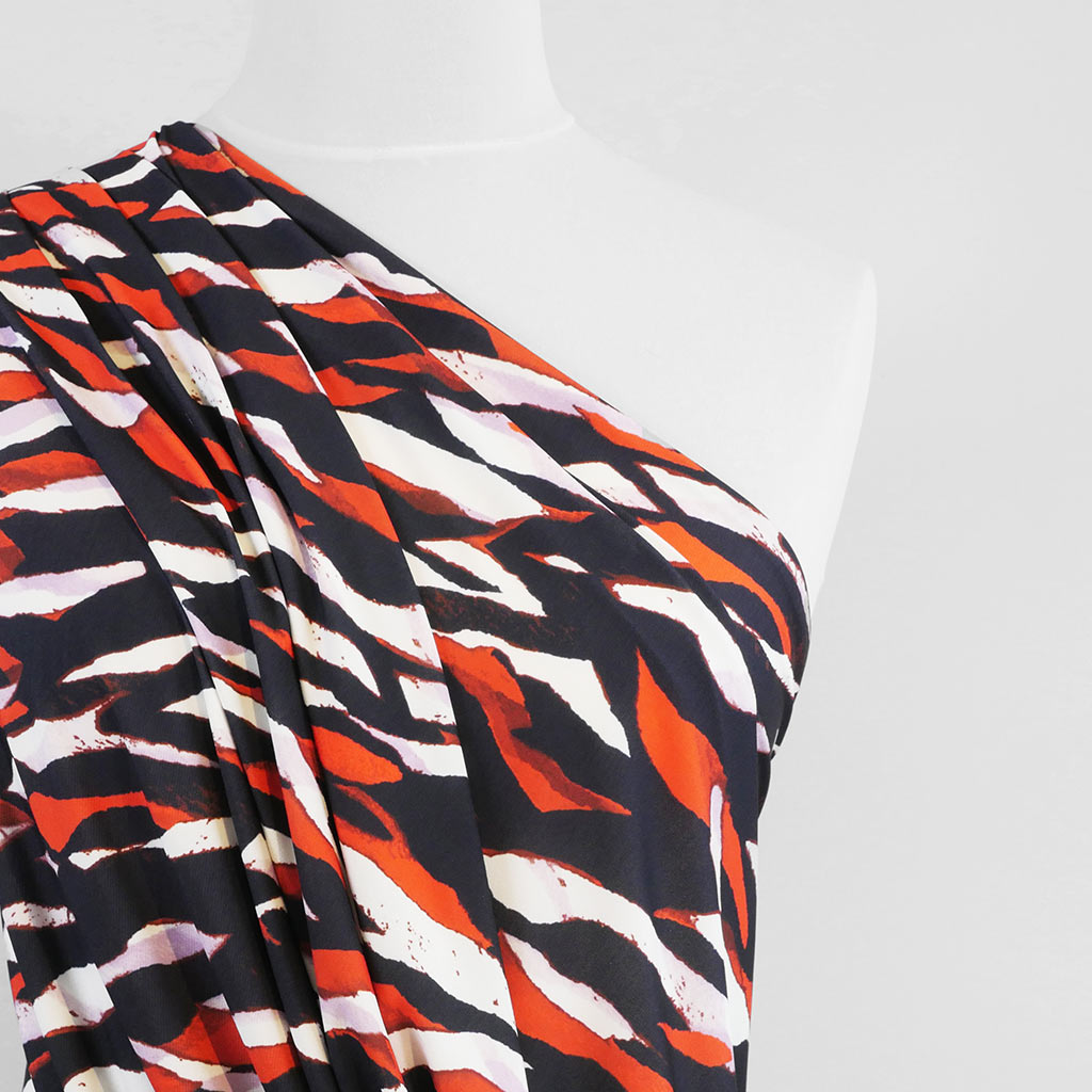 Portia - Navy and Orange Fracture Stretch Jersey Fabric from John Kaldor