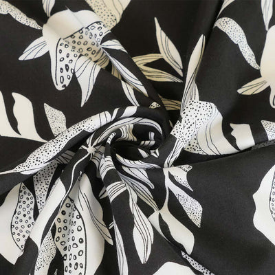 Sierra - Black Leaves Viscose Poplin Woven Fabric Detail Swirl Image from Patternsandplains.com