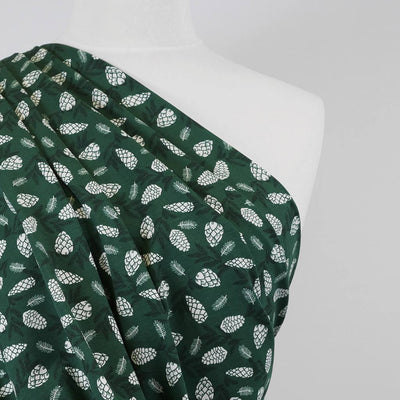 Arizona - Bottle Green Pine Cones, Single Jersey Cotton Elastane Print Fabric Mannequin Close Up Image from Patternsandplains.com