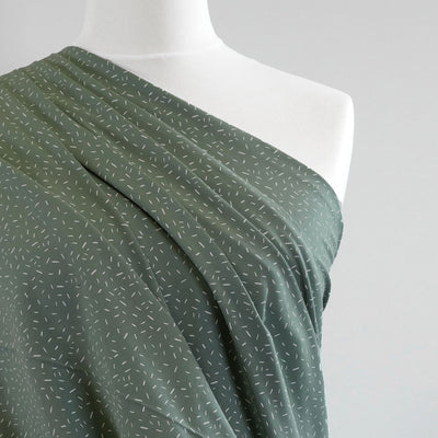 Arizona - Pistachio Green Ticker Tape, Single Jersey Cotton Elastane Print Fabric Mannequin Close Up Image from Patternsandplains.com
