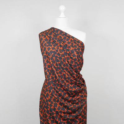 Madrid 4616 - Orange and Navy Scribbled Squares Woven Crepe Fabric from John Kaldor Mannequin Wide Image from Patternsandplains.com