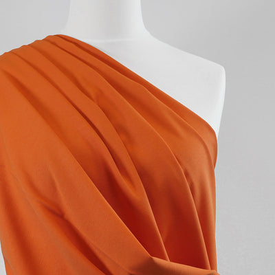 Milan - Pumpkin Orange Viscose Rich Ponte de Roma Fabric Mannequin Close Up Image from Patternsandplains.com