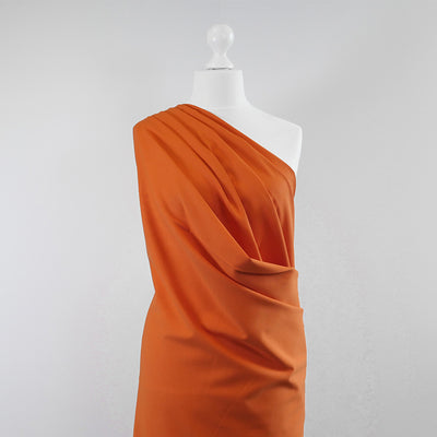 Milan - Pumpkin Orange Viscose Rich Ponte de Roma Fabric Mannequin Wide Image from Patternsandplains.com