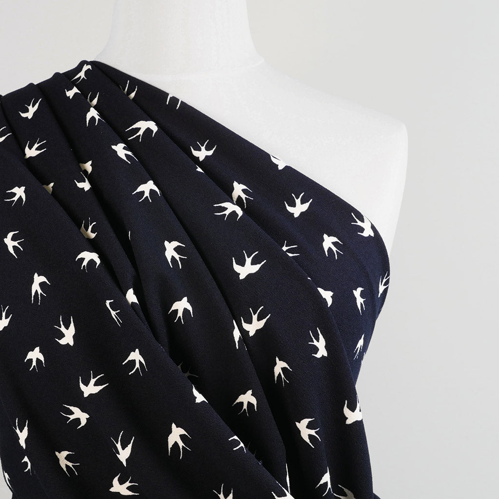 Alton - Navy Swallows Stretch Scuba Crepe Fabric Mannequin Close Up Image from Patternsandplains.com