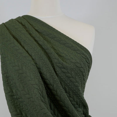 Bergen - Sage Green Aran Cables Double Jersey Blister Fabric Mannequin Close Up Image from Patternsandplains.com