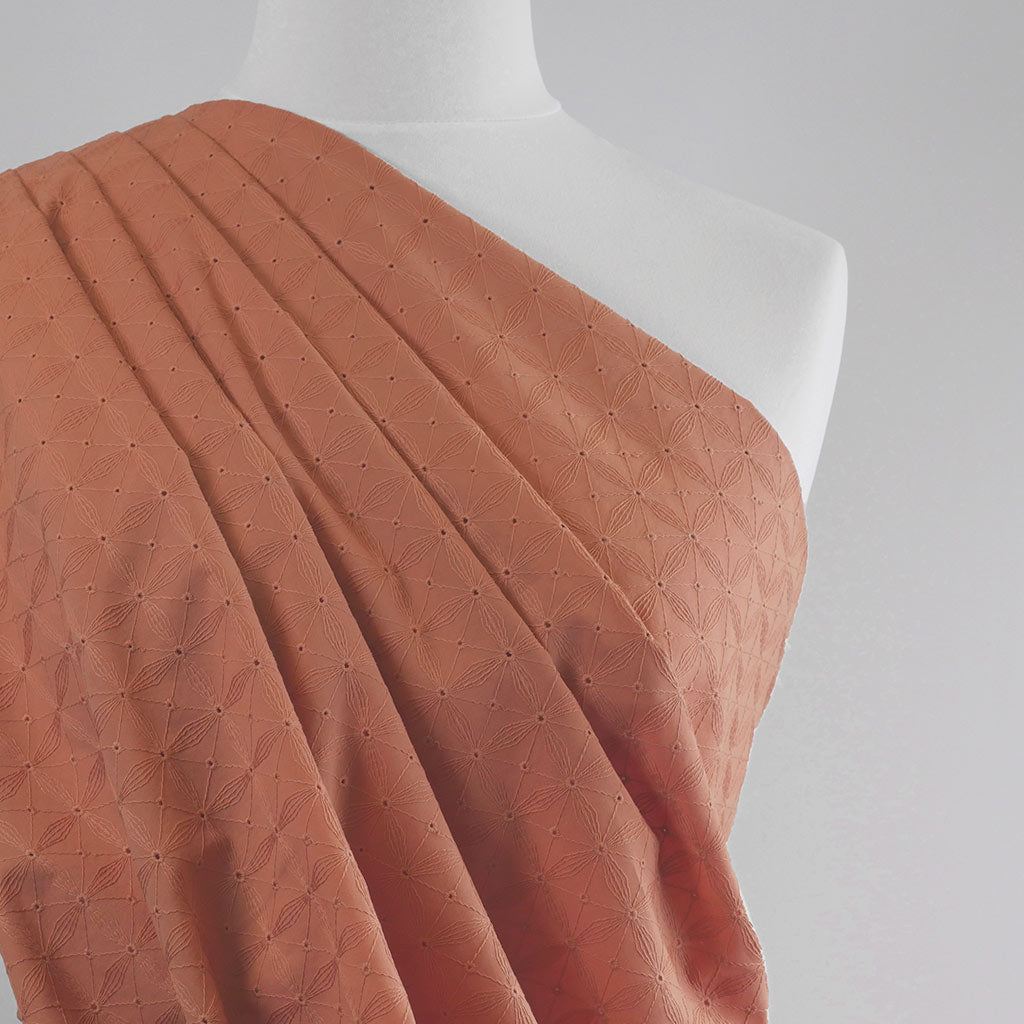 Carolina - Dark Peach, Geometric Embroidered Cotton Woven Fabric Mannequin Close Up Image from Patternsandplains.com