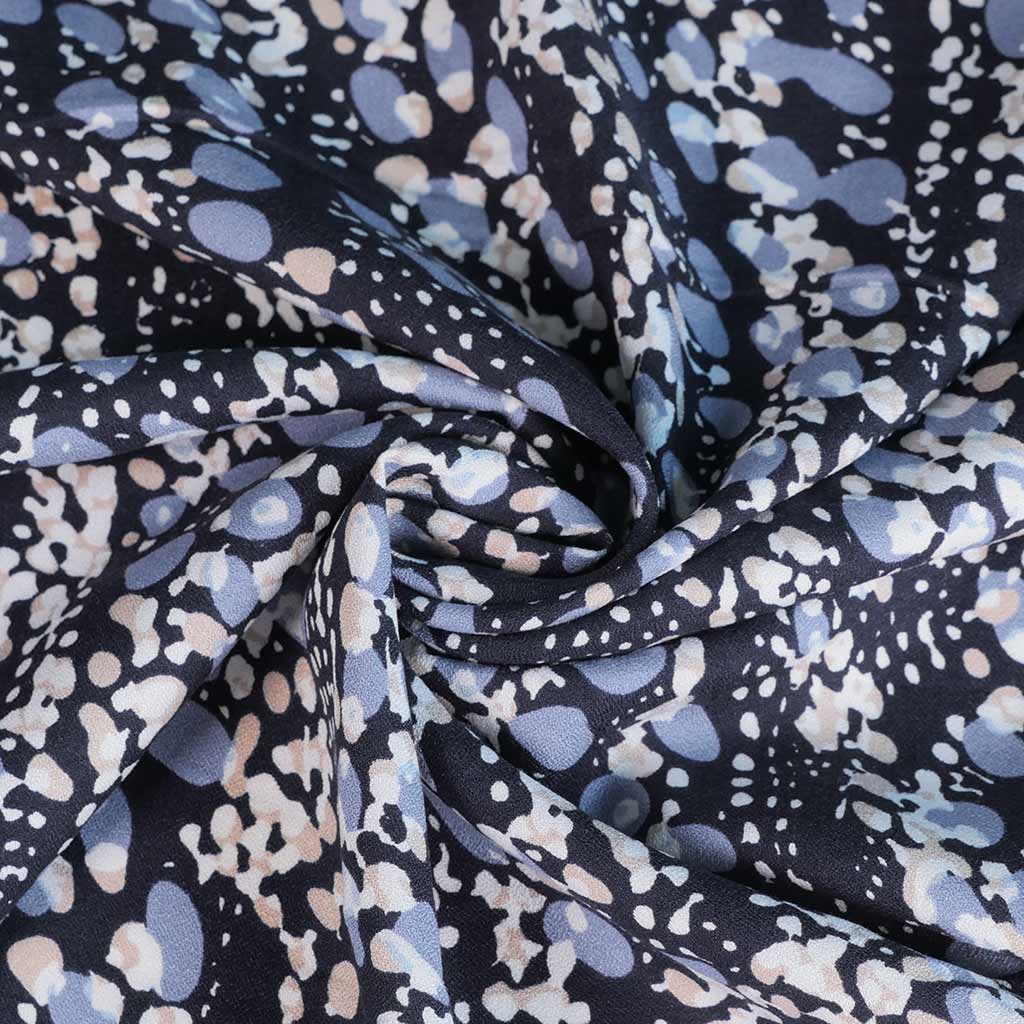 Cassis - Navy Larva Spots Viscose Crepe Woven Fabric Detail Swirl Image from Patternsandplains.com