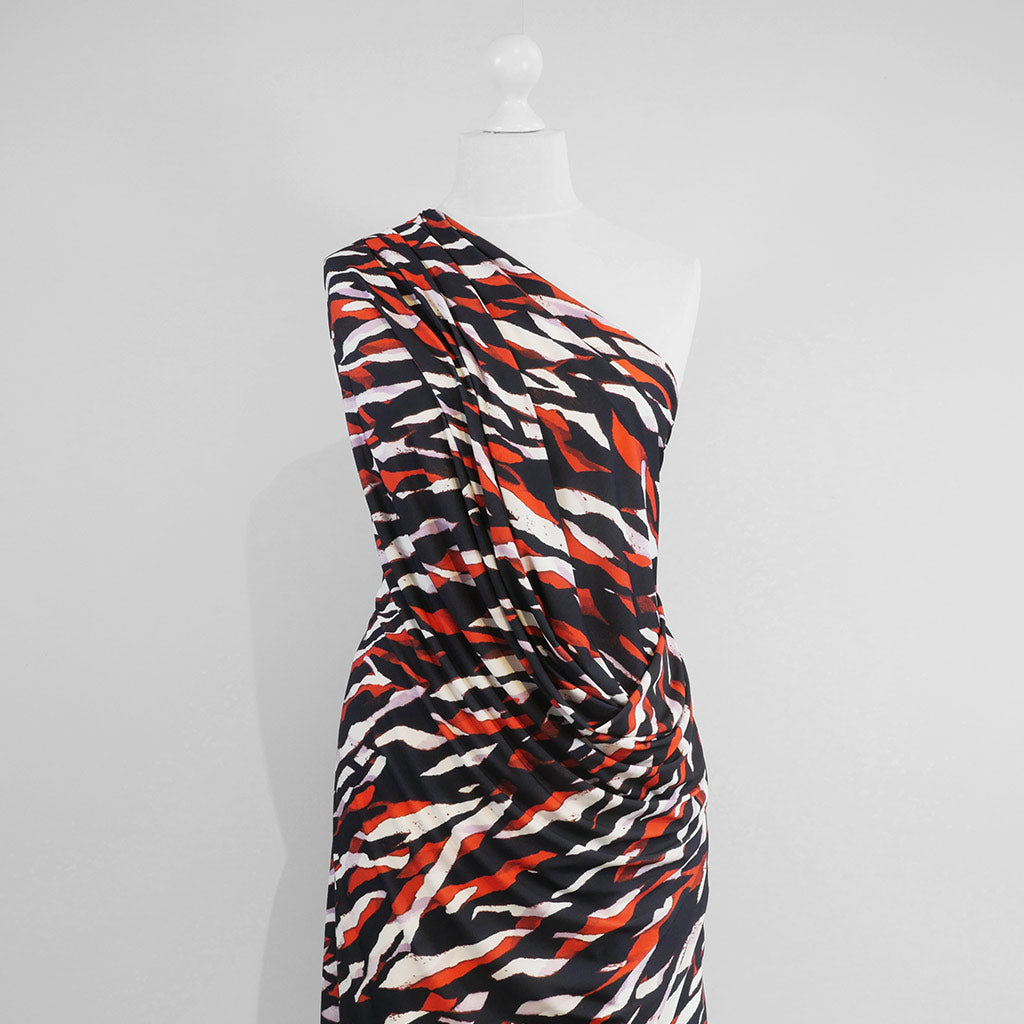 Portia - Navy and Orange Fracture Stretch Jersey Fabric from John Kaldor Mannequin Wide Image from Patternsandplains.com