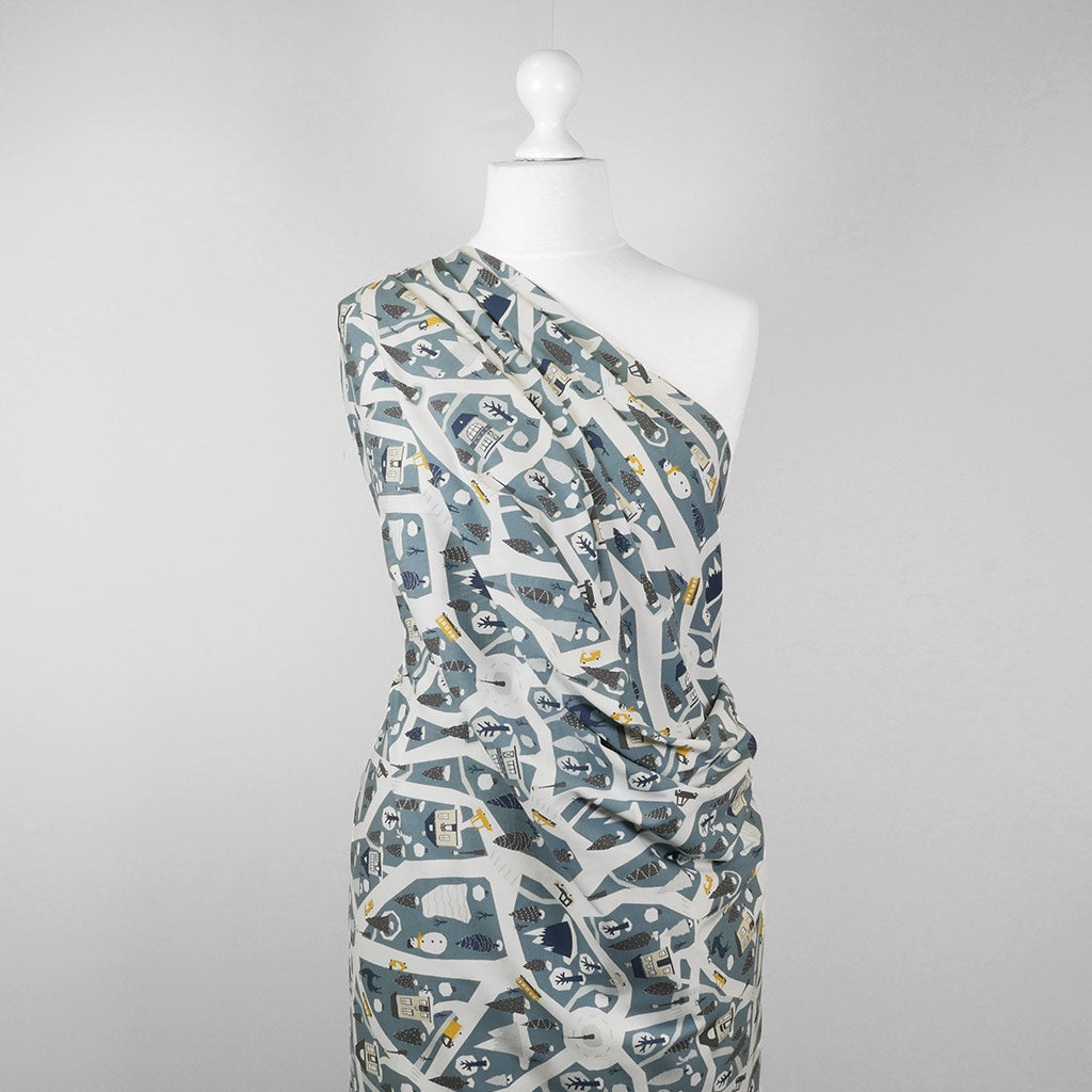 Arizona - Dusty Blue Winter Village, Single Jersey Cotton Elastane Print Fabric Mannequin Wide Image from Patternsandplains.com