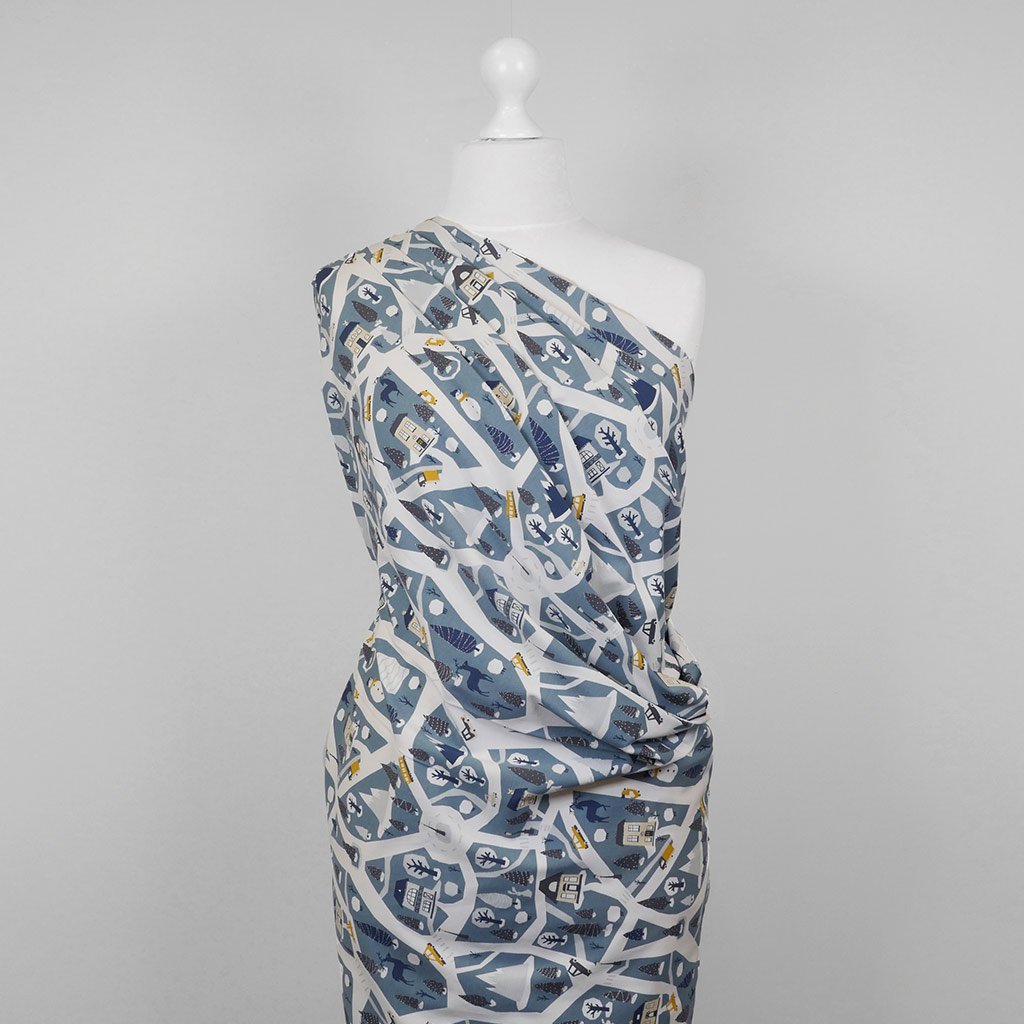 Arizona - Dusty Blue Winter Village, Single Jersey Cotton Elastane Print Fabric Mannequin Wide Image from Patternsandplains.com