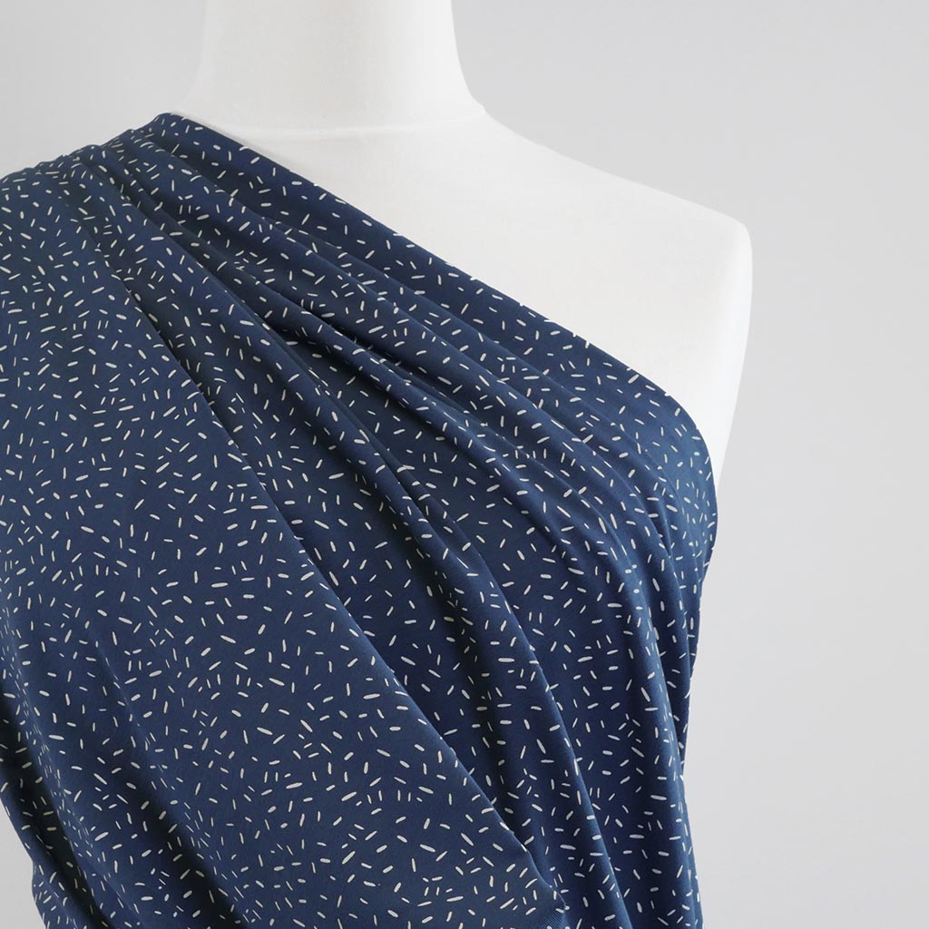 Arizona - Denim Blue Ticker Tape, Single Jersey Cotton Elastane Print Fabric Mannequin Close Up Image from Patternsandplains.com