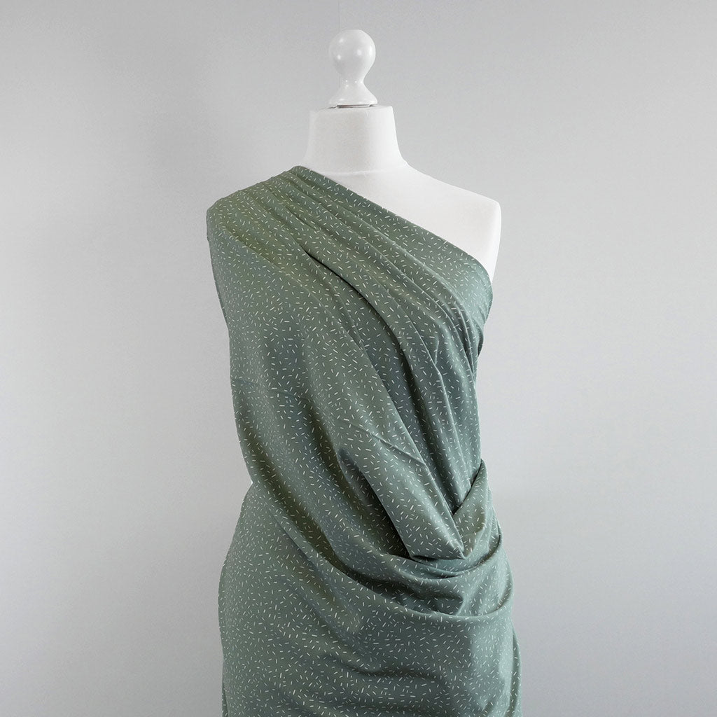 Arizona - Pistachio Green Ticker Tape, Single Jersey Cotton Elastane Print Fabric Mannequin Wide Image from Patternsandplains.com