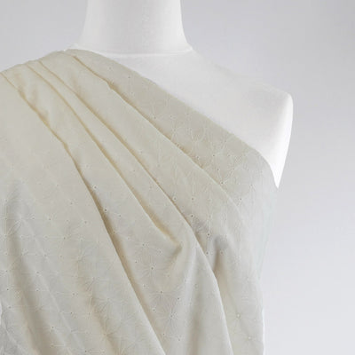Carolina - Light Cream, Geometric Embroidered Cotton Woven Fabric Mannequin Close Up Image from Patternsandplains.com