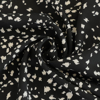 Linz- Black Animal Elements Viscose Woven Twill Fabric Detail Swirl Image from Patternsandplains.com