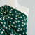 Loire Green Double Daisies Viscose Crepe Fabric Mannequin Closeup Image from Patternsandplains.com