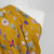 Monroe - Amber Yellow, Garland Woven Crepe Fabric Mannequin Close Up Image from Patternsandplains.com