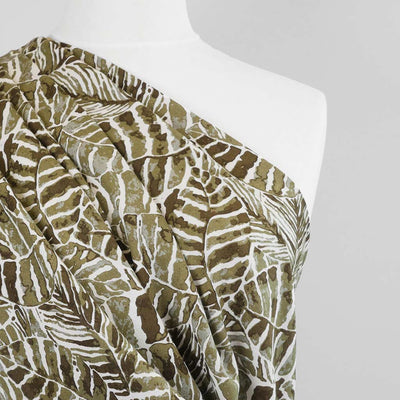 Palermo - Olive Green Leaves Viscose Linen Woven Fabric Mannequin Close Up Image from Patternsandplains.com