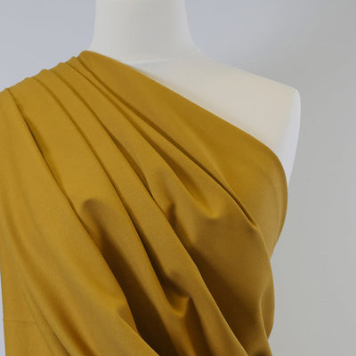 Rome Ochre Yellow Viscose Rich Heavy Ponte de Roma Stretch Fabric Mannequin Closeup Image from Patternsandplains.com