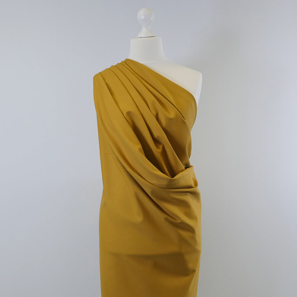 Rome Ochre Yellow Viscose Rich Heavy Ponte de Roma Stretch Fabric Mannequin Wide Image from Patternsandplains.com
