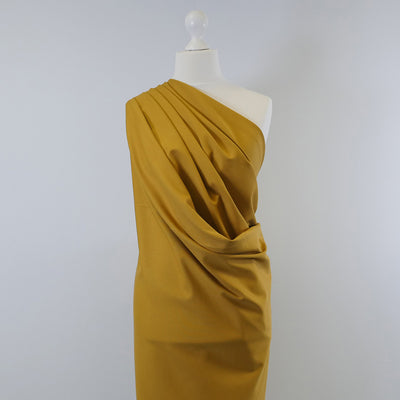 Rome Ochre Yellow Viscose Rich Heavy Ponte de Roma Stretch Fabric Mannequin Wide Image from Patternsandplains.com